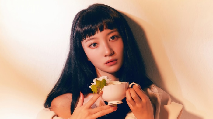 Yubin from Oh My Girl holding a cup