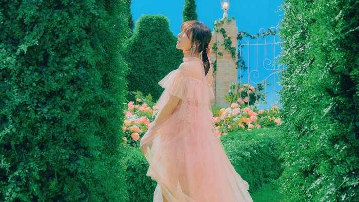 Wendy from Red Velvet in pink dress in garden