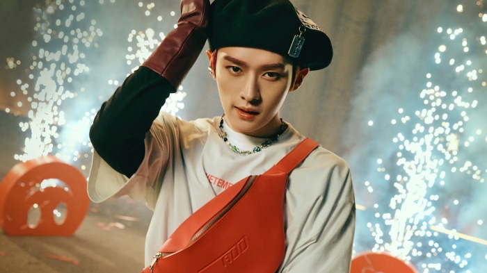 Lee Know from Stray Kids wearing a beret and fanny pack