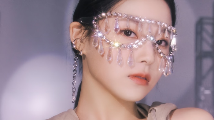 Kyujin from NMIXX wearing a jeweled mask