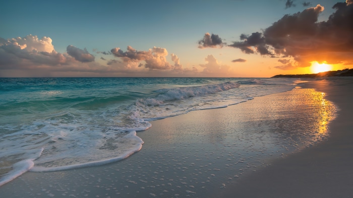 Beach with waves at sunset 4K