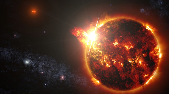 Sun with solar flare and distant stars