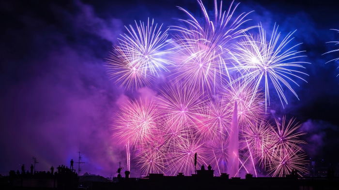 Fireworks display over city skyline at night