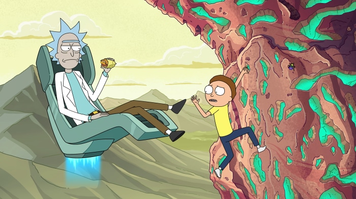 Rick from Rick and Morty eating a sandwich while Morty climbs a rock