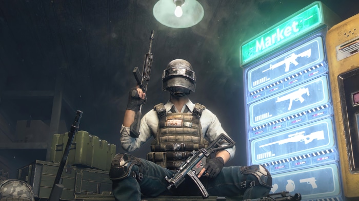 Player in PUBG Mobile holding weapons near a market stall