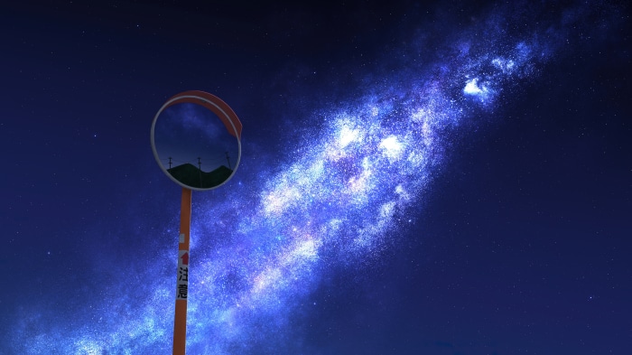 Road mirror reflecting hills under a starry night sky with the Milky Way