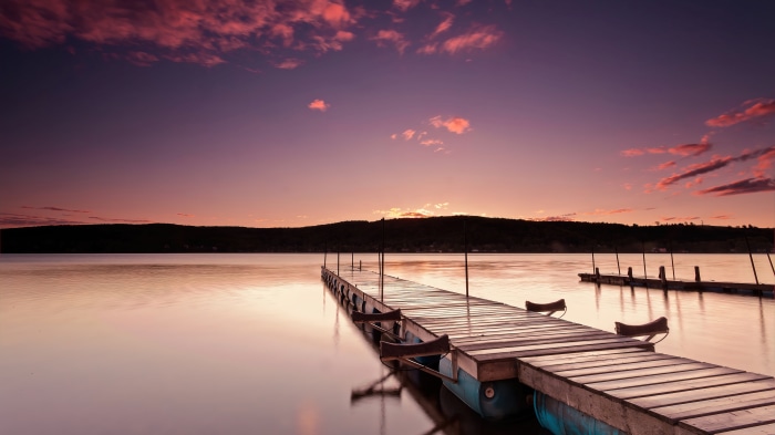 Wooden dock on a lake at sunrise