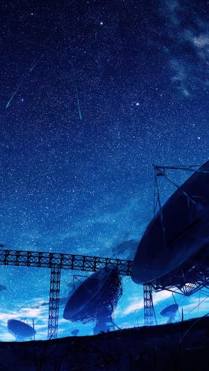 Satellite dishes under a starry night sky with shooting stars