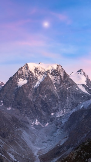 Snow-capped mountain under a twilight sky