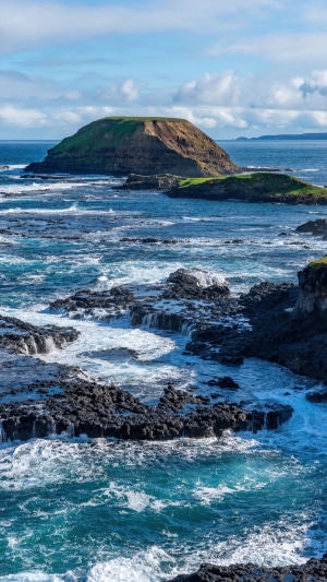 Rocky coastline with island in the sea