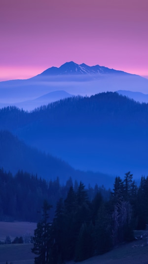 Mountain range at sunrise with purple sky