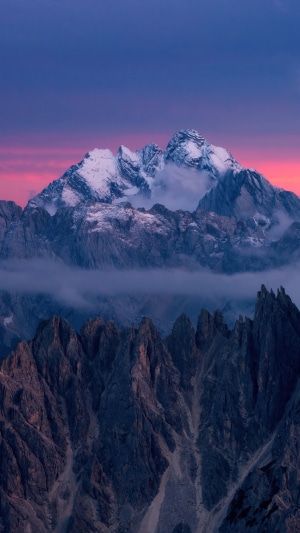 Snow-capped mountains at sunset with dramatic sky