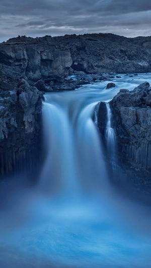 Waterfall cascading over rocky cliffs