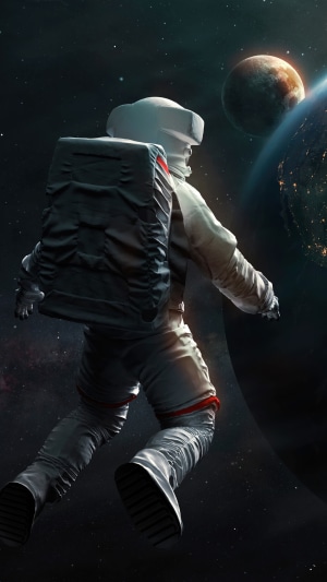 Astronaut floating in space near planets