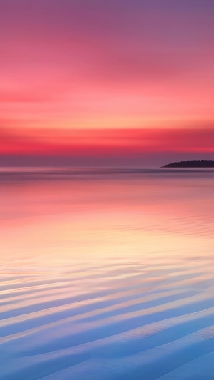 Sunset over the ocean with island silhouette