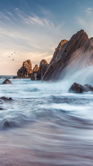 Waves crashing on rocks at Corona Del Mar, California