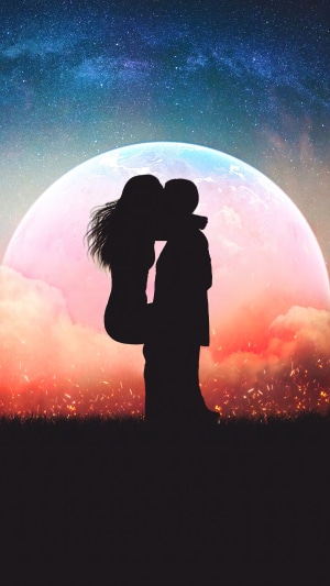 Couple kissing under the moon and stars