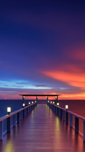 Wooden pier at sunset over the ocean