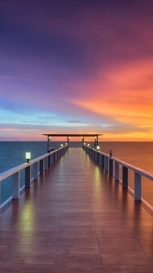 Wooden pier at sunset over the ocean