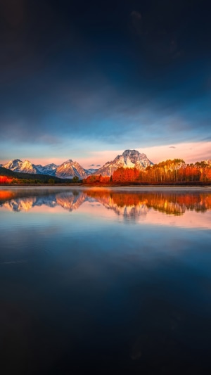 Sunrise over mountains reflected in a lake