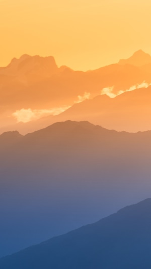 Mountain range at sunset with orange clouds