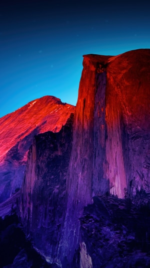 Half Dome mountain at sunset with red and purple light
