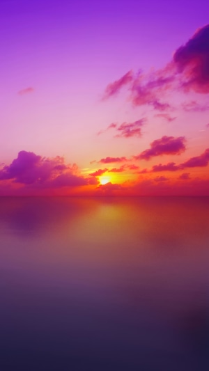 Sunset over the ocean with purple clouds