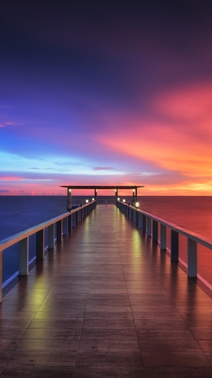 Wooden pier at sunset over the ocean