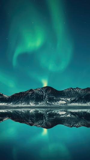 Aurora Borealis over Mountains and Lake in Iceland