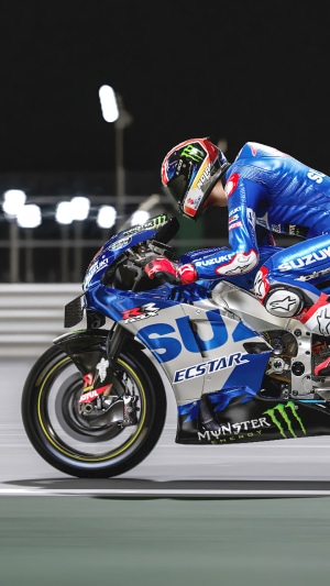 Motorcycle racer in blue suit on Suzuki motorcycle