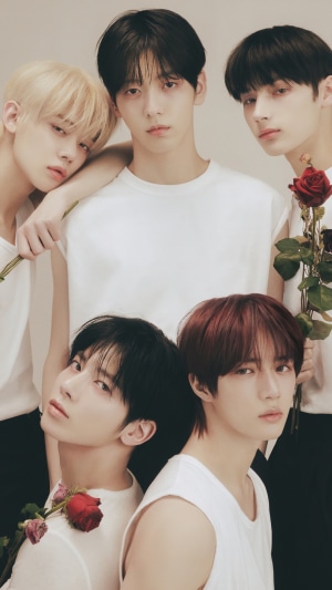 TXT members in white tops with roses