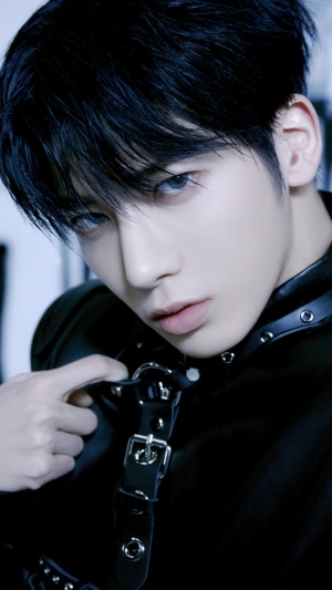 Taehyun from TXT wearing a black harness