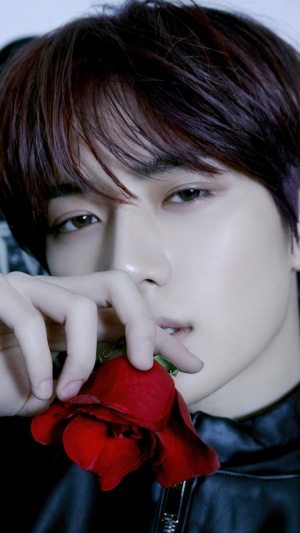 Beomgyu from TXT holding a red rose
