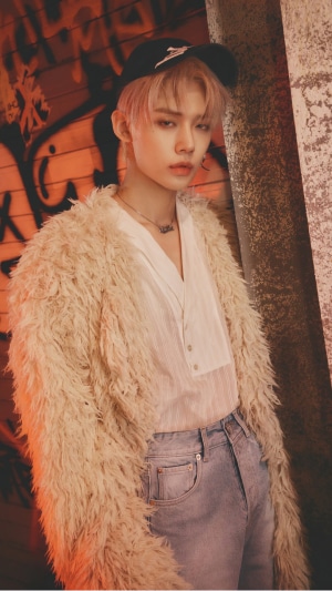 Yeonjun from TXT wearing a fluffy coat and jeans
