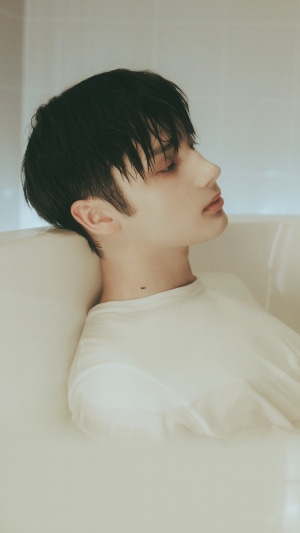 Huening Kai from TXT in a bathtub