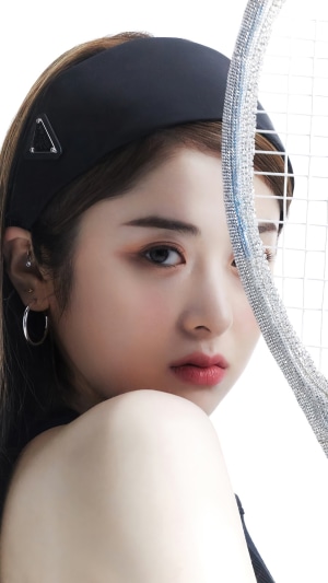 Huh Yunjin from LE SSERAFIM with a tennis racket