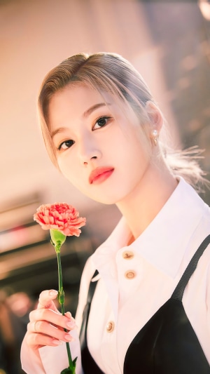 Sana from TWICE holding a flower