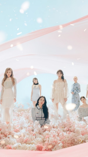 TWICE members in a floral and pastel setting