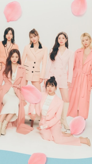 TWICE members in pink outfits with petals