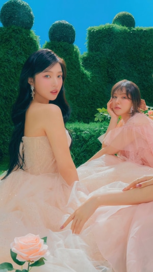 Red Velvet members Joy, Wendy, and Seulgi in a garden