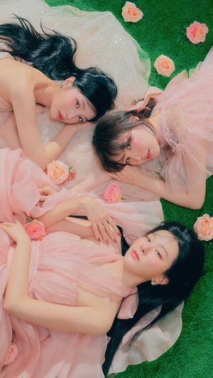Red Velvet members Joy, Wendy, and Seulgi in pink dresses