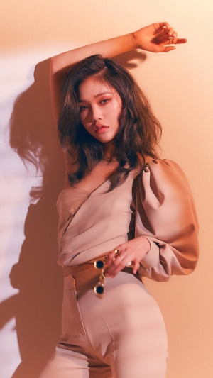 Mimi from Oh My Girl posing in a beige outfit