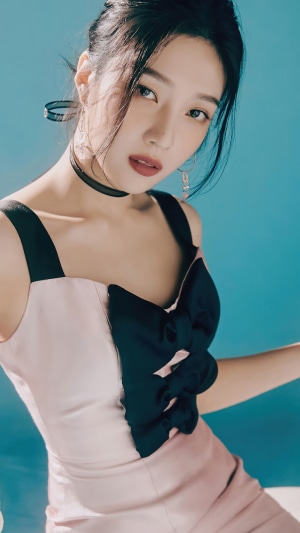 Joy from Red Velvet wearing a pink and black dress