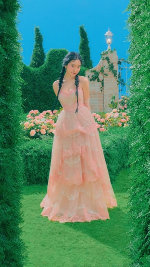 Yeri from Red Velvet in a pink dress in a garden