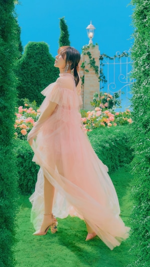Wendy from Red Velvet in a pink dress in a garden
