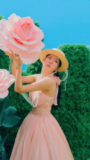 Seulgi from Red Velvet in a pink dress and hat