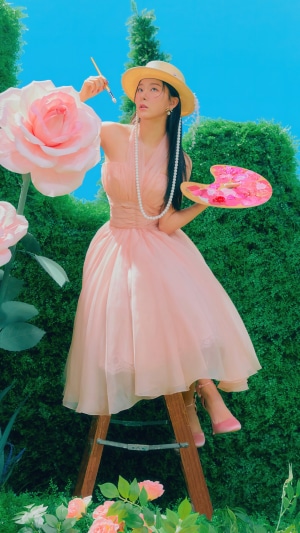 Seulgi from Red Velvet painting in a garden