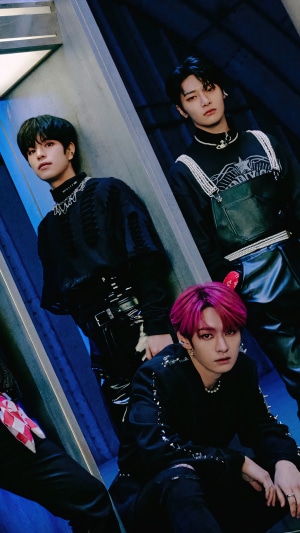 Stray Kids members in dark, futuristic outfits