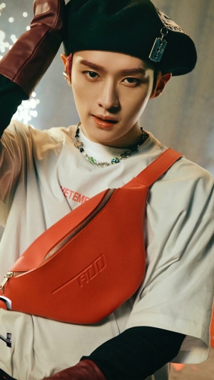 Lee Know from Stray Kids wearing a beret and fanny pack