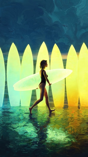 Surfer girl walking with surfboards at sunset